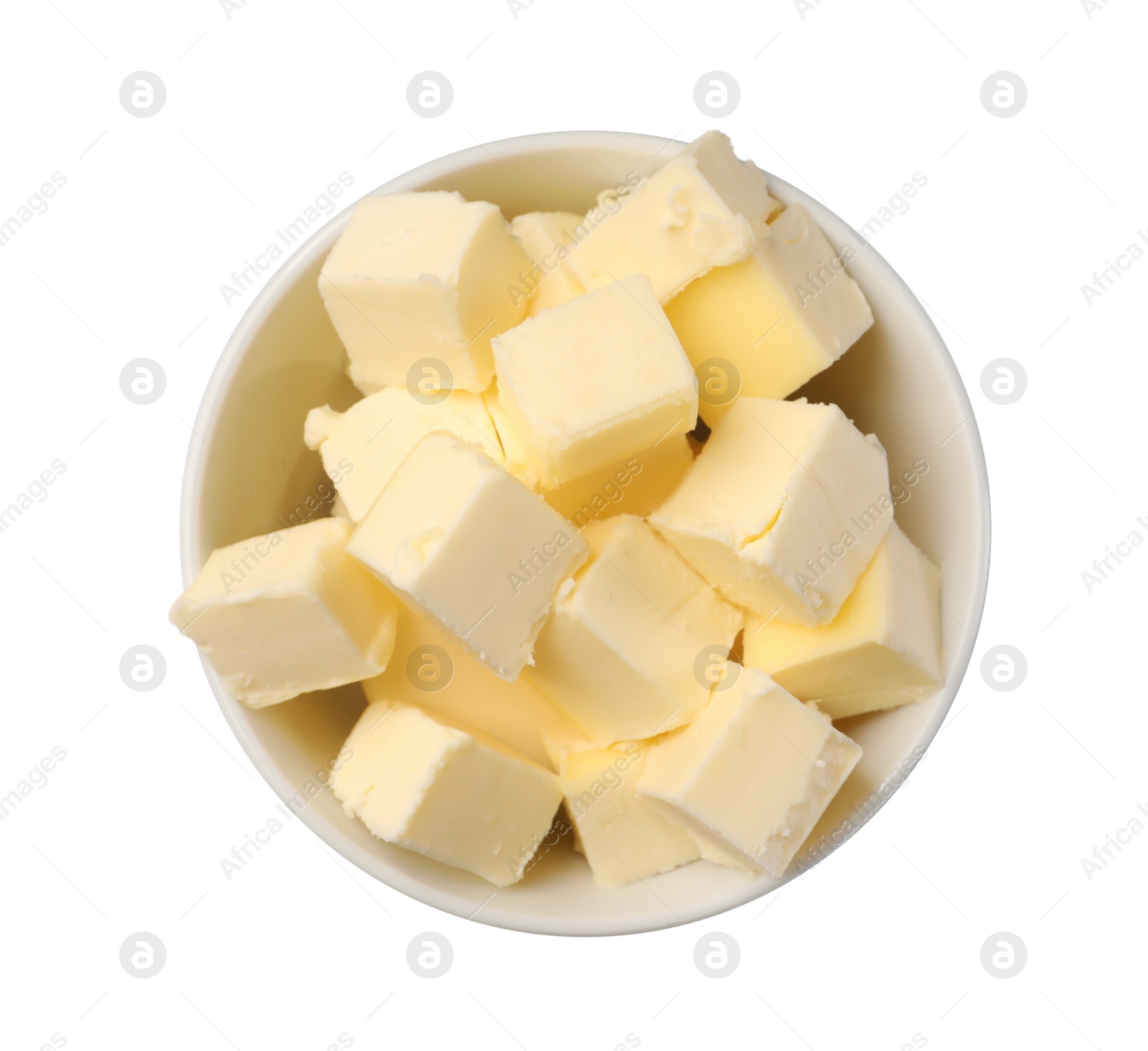 Photo of Tasty butter cubes in bowl isolated on white, top view