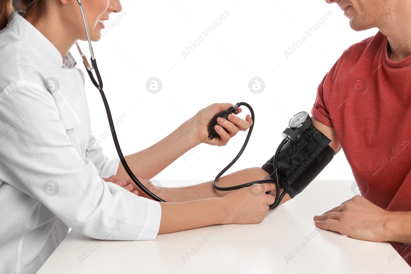Photo of Doctor checking patient's blood pressure against white background, closeup. Cardiology concept