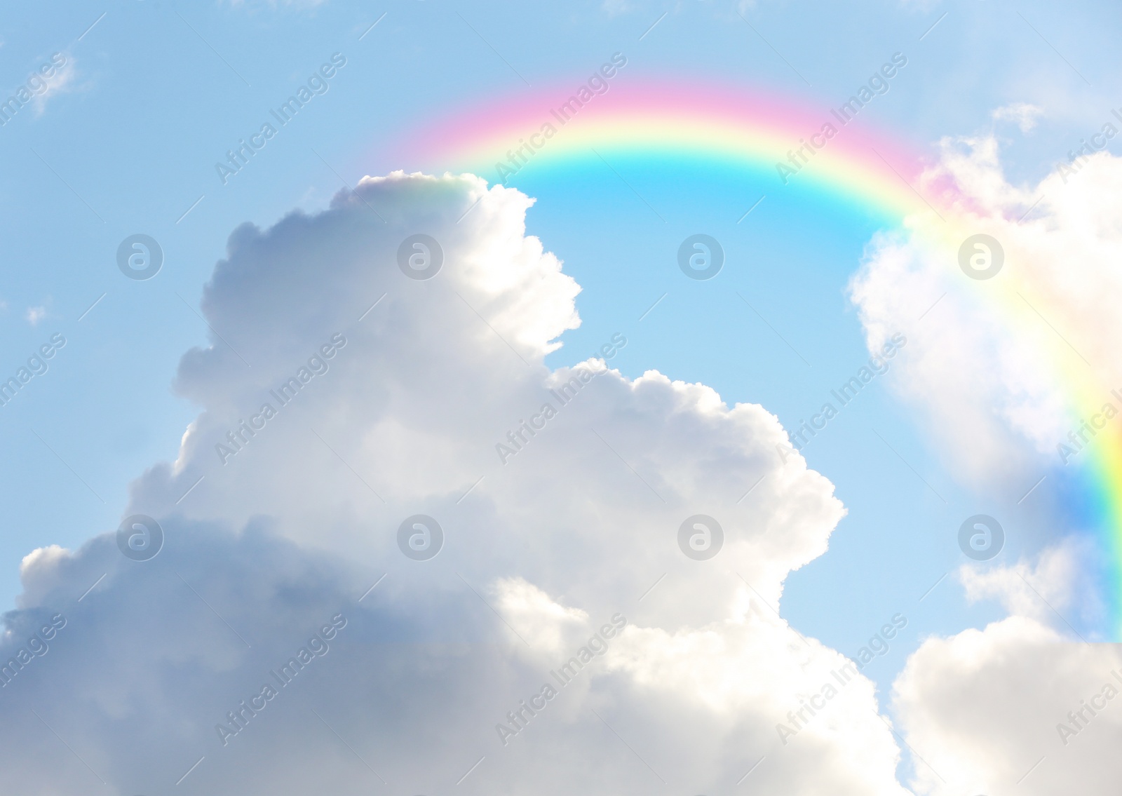 Image of Picturesque view of beautiful rainbow and blue sky on sunny day 