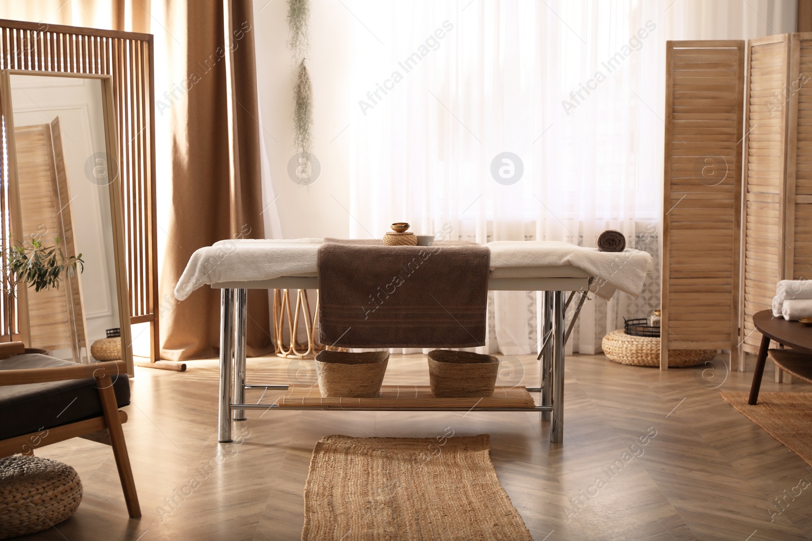 Photo of Stylish room interior with massage table in spa salon