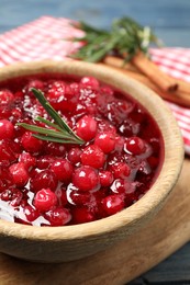 Photo of Fresh cranberry sauce with rosemary in bowl, closeup