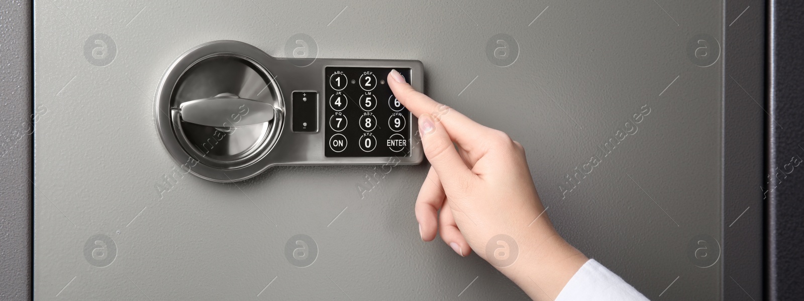 Image of Woman opening steel safe with electronic lock, closeup. Banner design