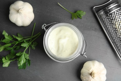 Photo of Flat lay composition with garlic sauce on grey background