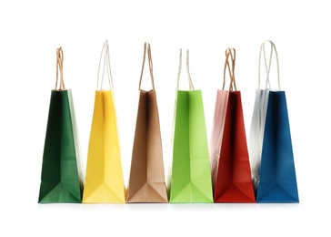 Photo of Empty paper shopping bags on white background