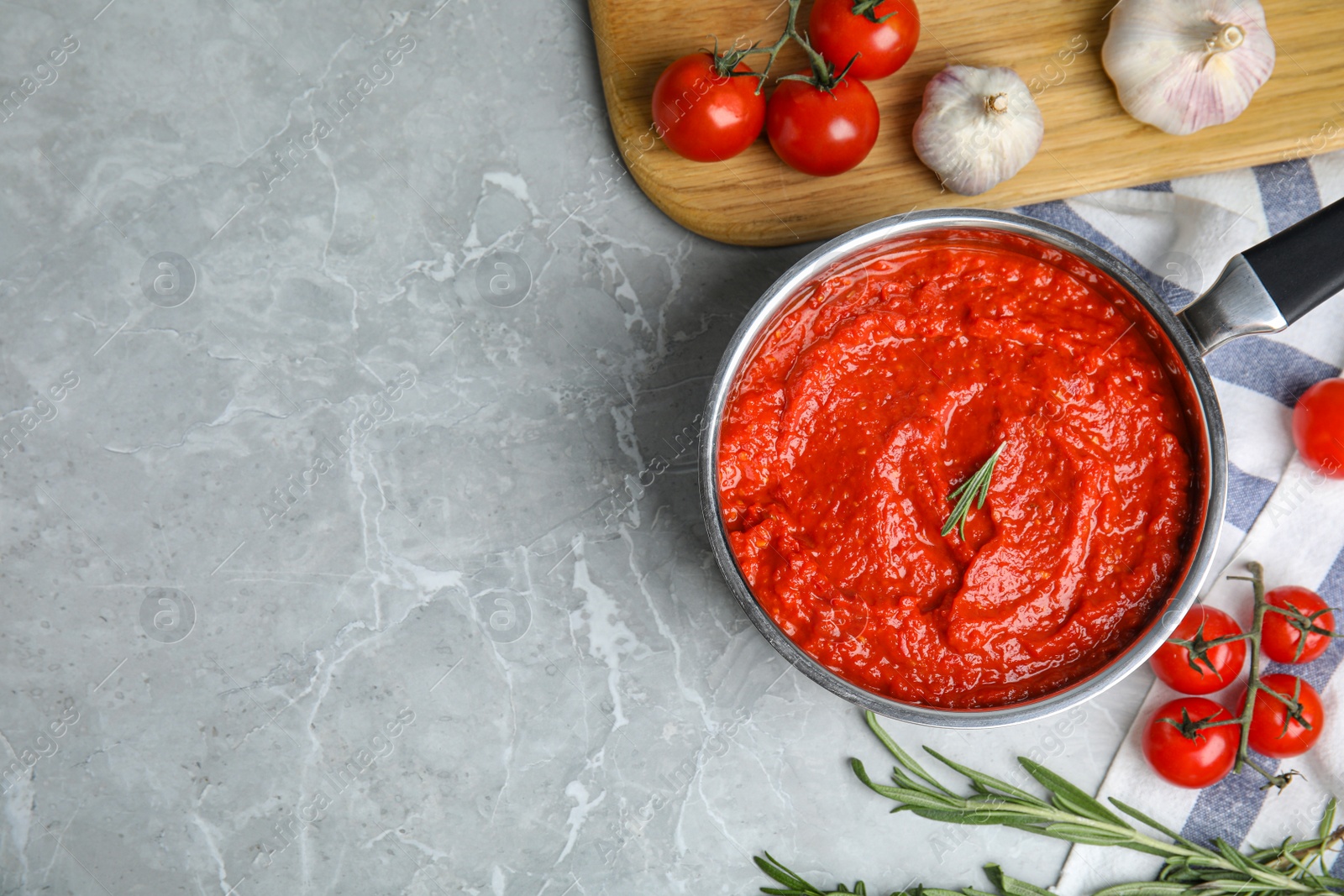 Photo of Flat lay composition with delicious tomato sauce on marble table. Space for text