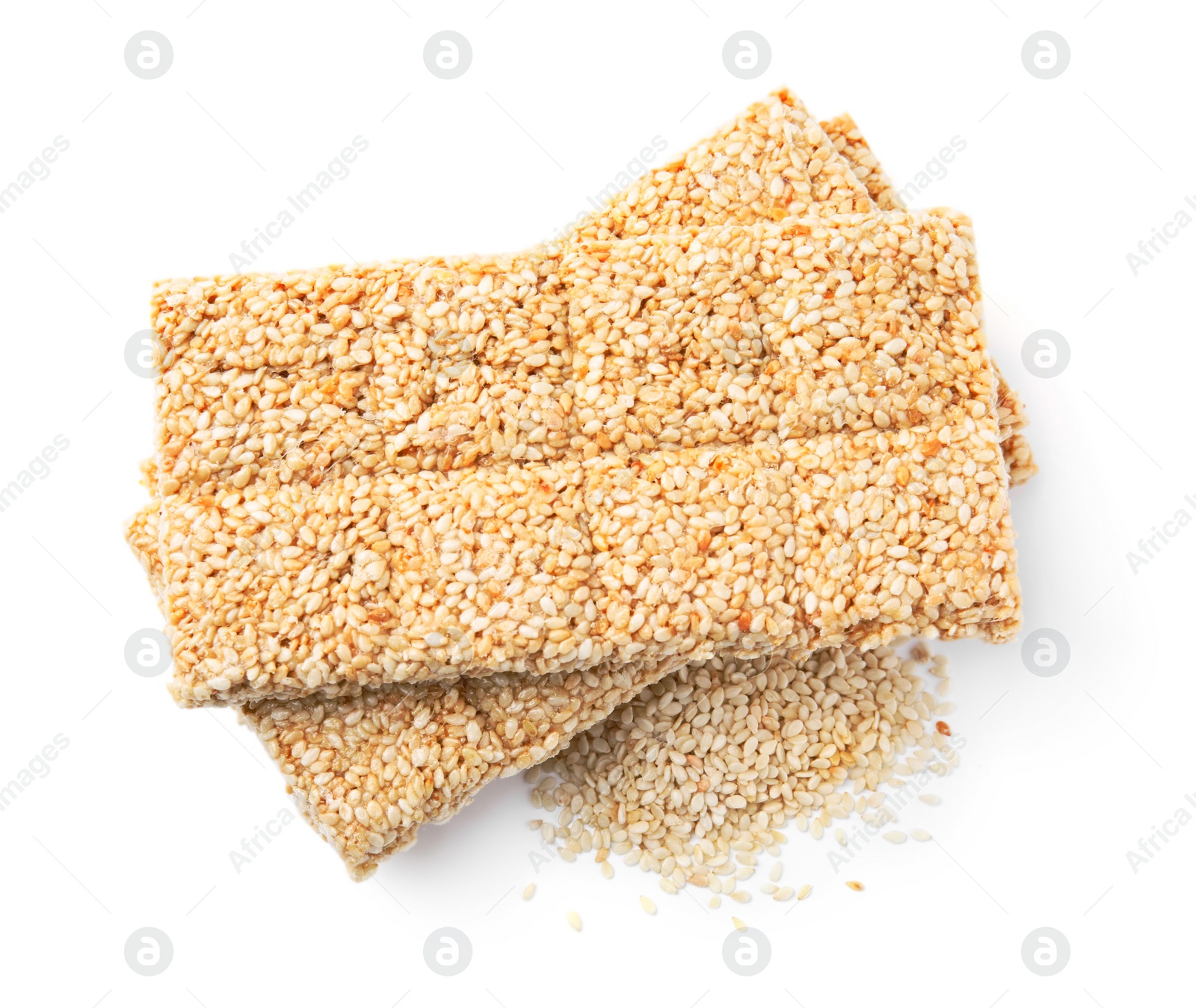 Photo of Tasty sweet kozinaki bars and sesame seeds on white background, top view