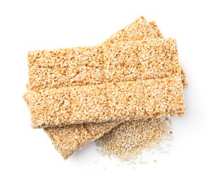 Tasty sweet kozinaki bars and sesame seeds on white background, top view