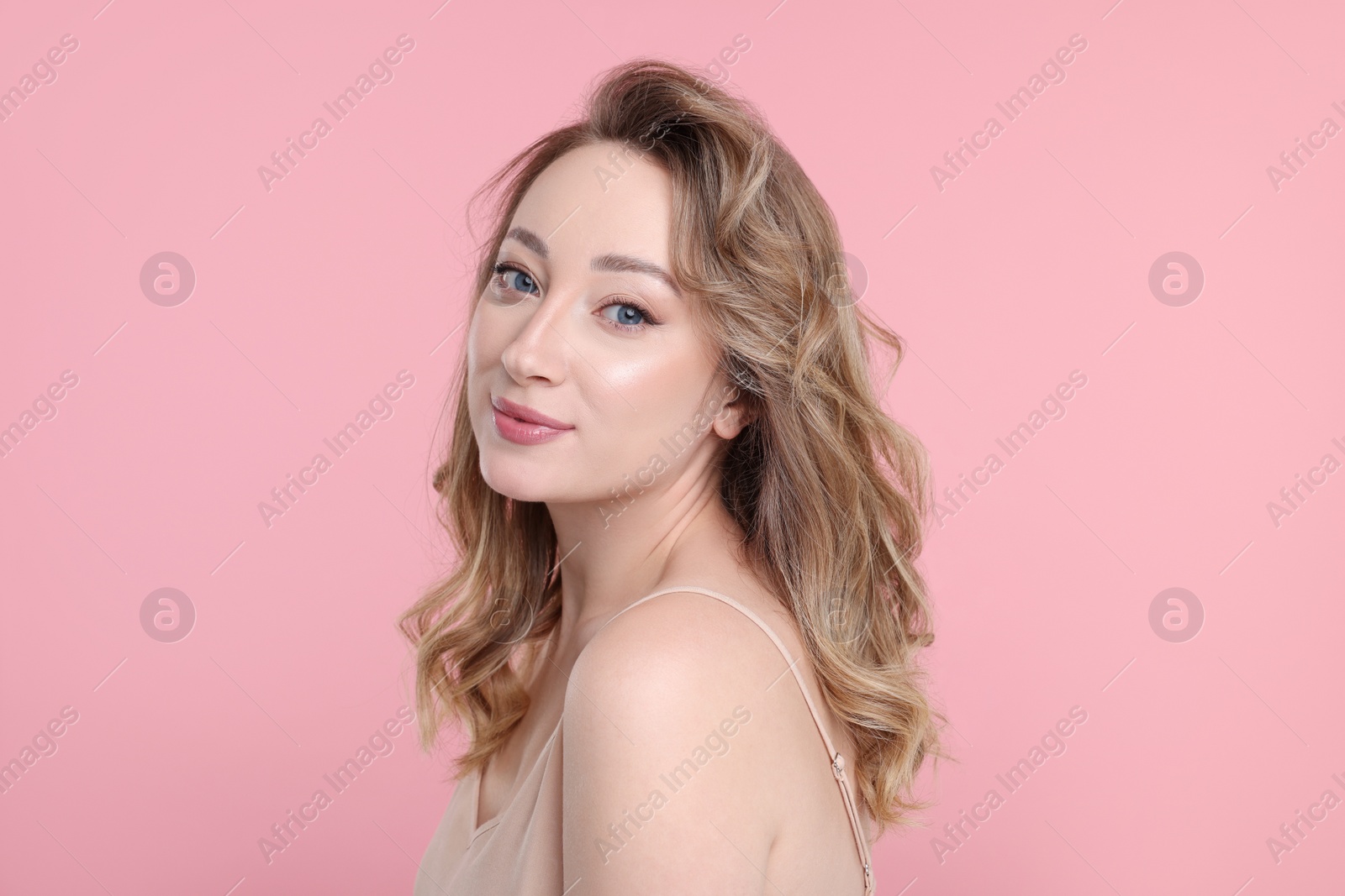 Photo of Portrait of beautiful woman on pink background