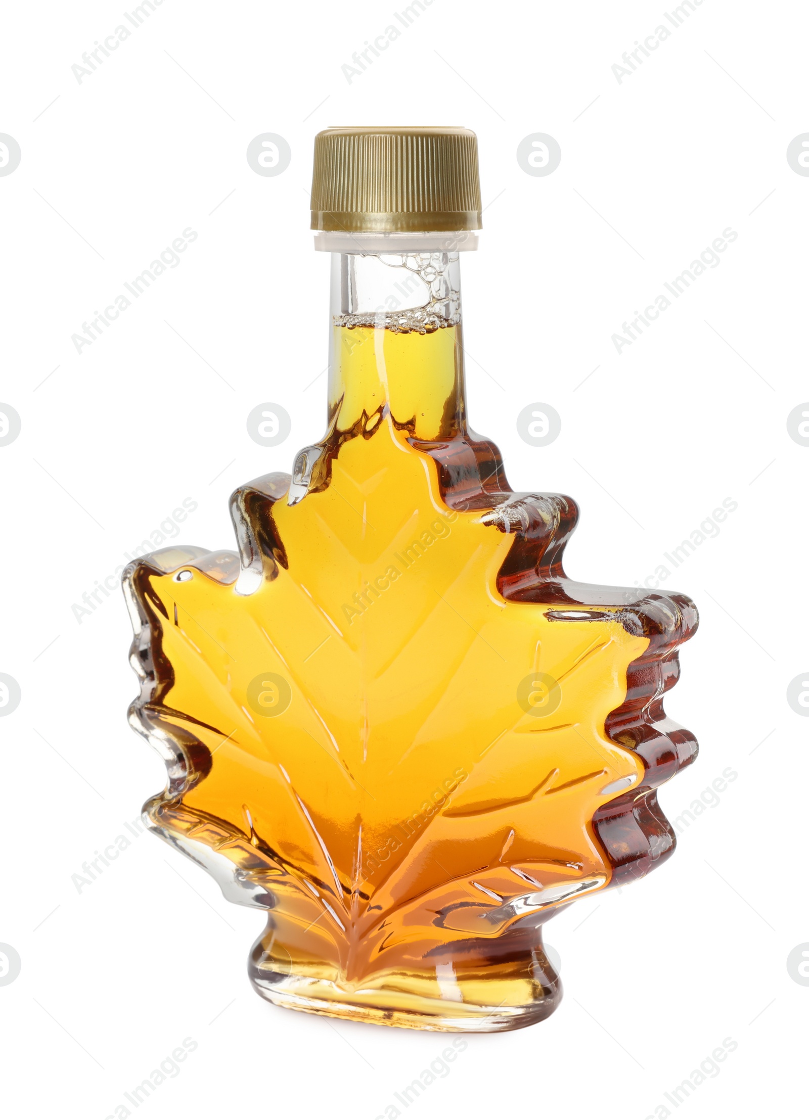 Photo of Leaf shaped bottle of tasty maple syrup isolated on white