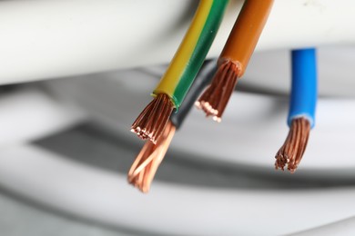 Photo of Colorful electrical wires on blurred background, closeup