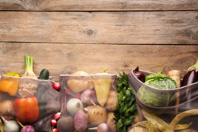 Photo of Different fresh ripe vegetables on wooden table, flat lay. Space for text