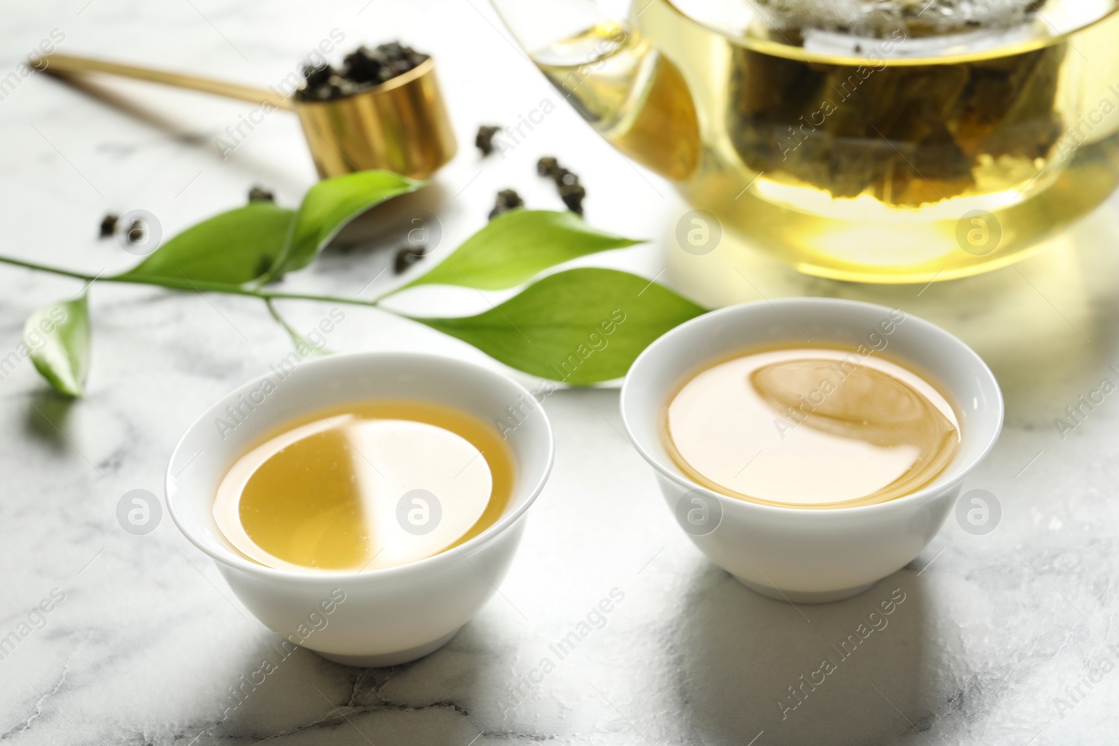 Photo of Cups of Tie Guan Yin oolong tea on marble table