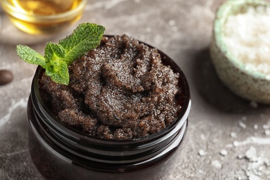 Jar with handmade natural body scrub on table, closeup