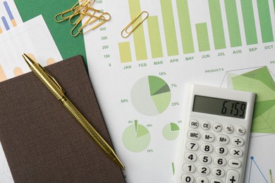 Photo of Accounting documents, magnifying glass, calculator and stationery on green background, flat lay