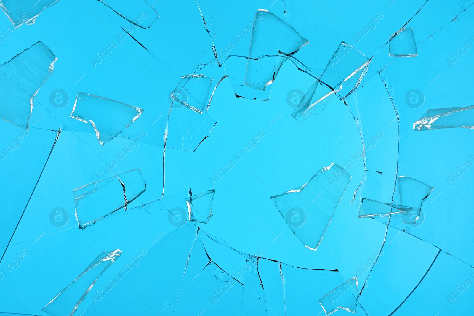 Image of Broken glass with cracks on blue background