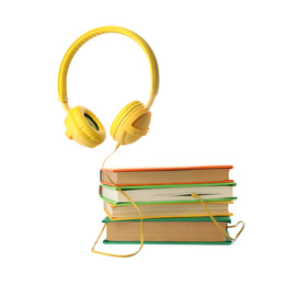 Books and modern headphones isolated on white