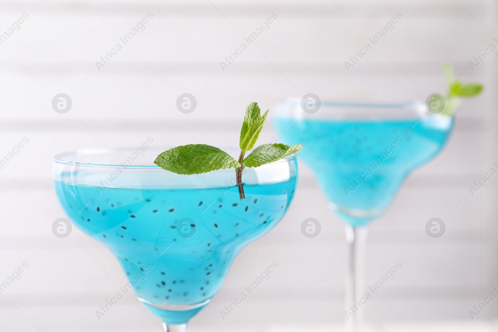 Photo of Delicious cocktail with basil seeds and mint on white background, closeup