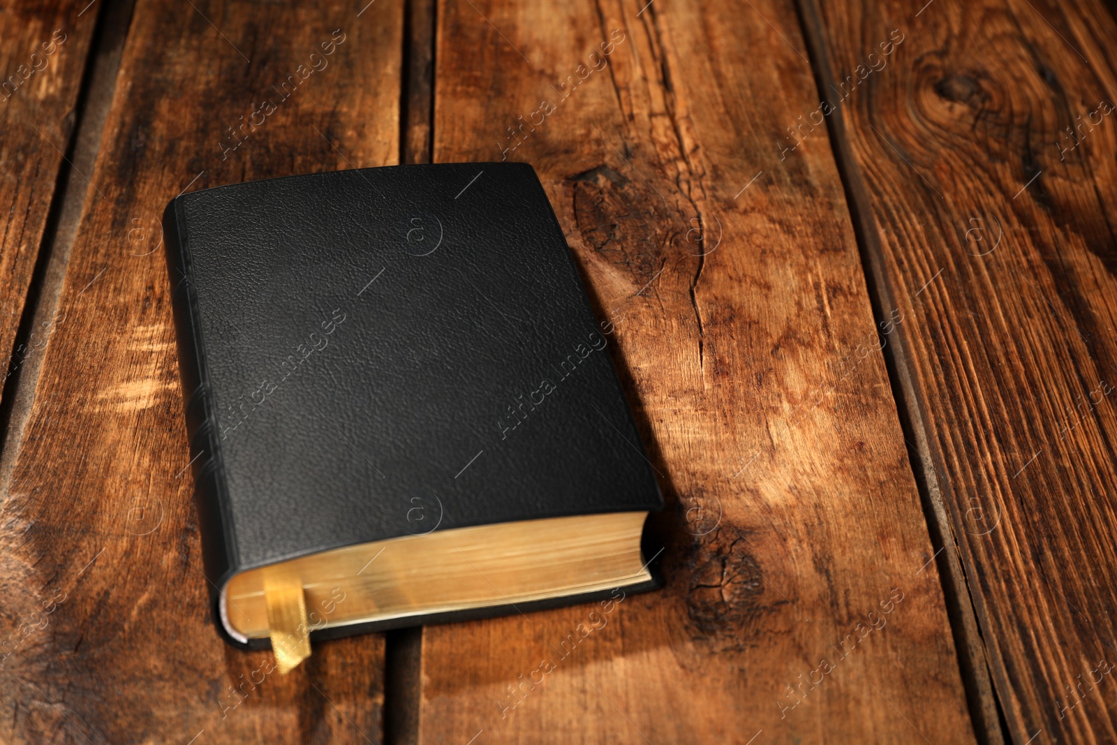 Photo of Bible on wooden table. Christian religious book