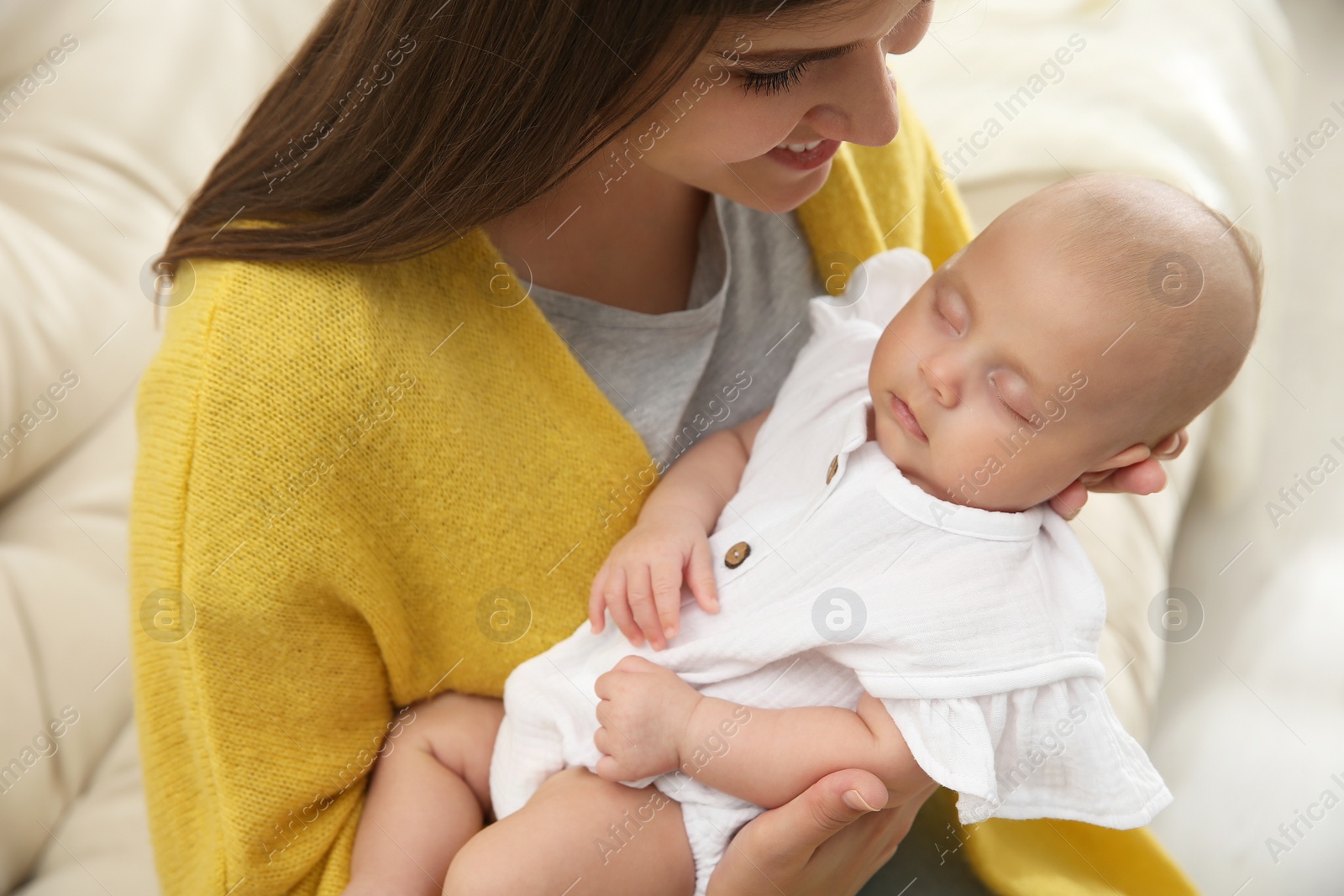 Photo of Mother with her sleeping baby on sofa, closeup