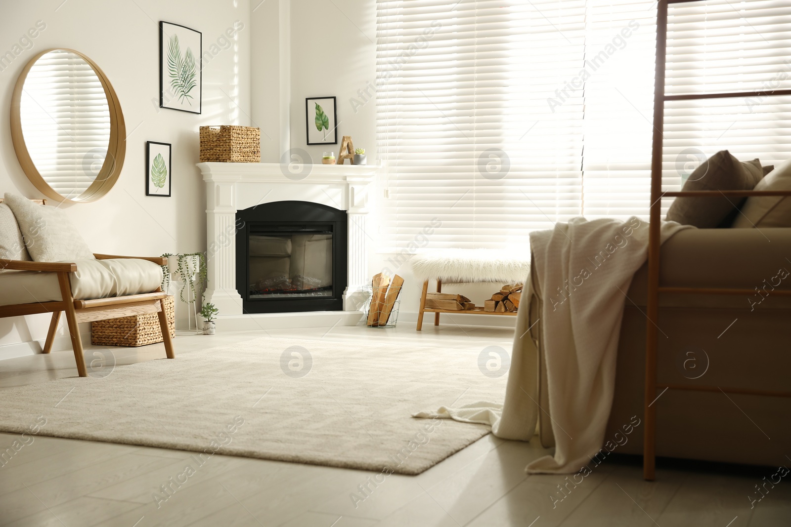 Photo of Bright living room interior with fireplace, armchair and sofa against white wall