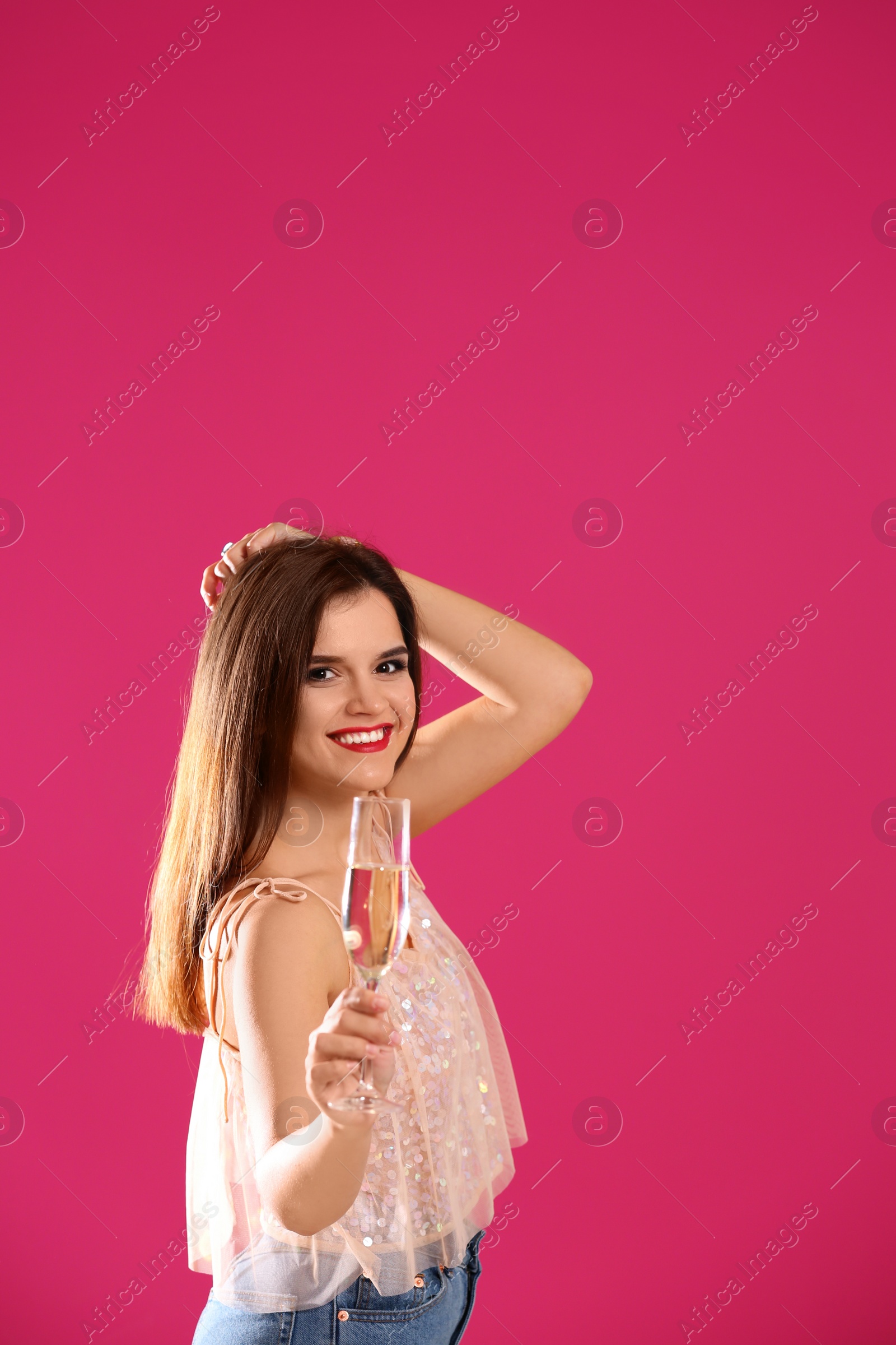 Photo of Portrait of happy woman with champagne in glass on color background