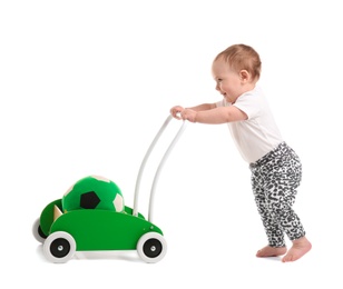 Photo of Cute baby with toy walker on white background