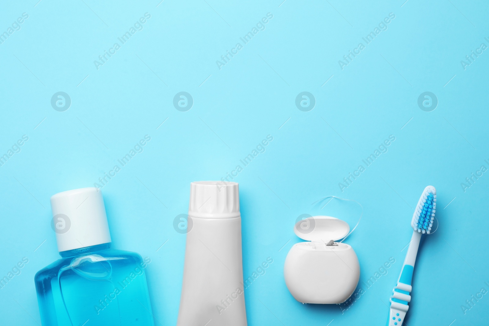 Photo of Flat lay composition with toothpaste, oral hygiene products and space for text on color background