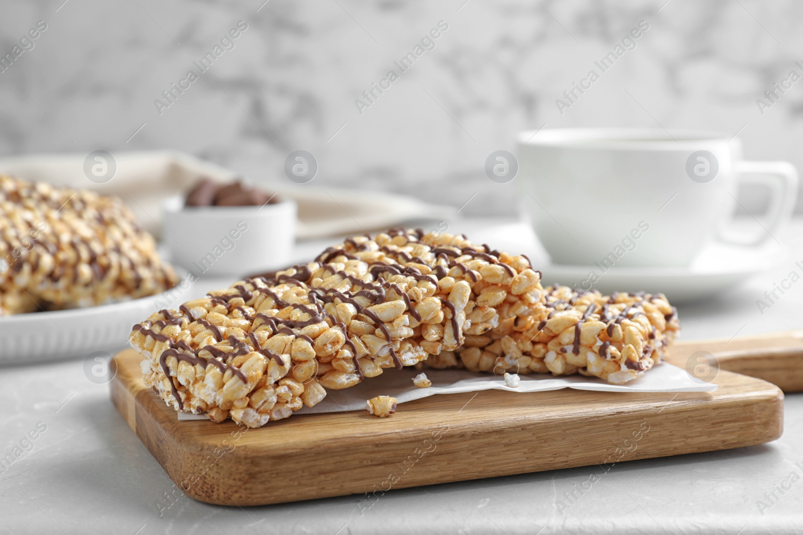 Photo of Delicious rice crispy treats on grey table