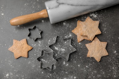 Flat lay composition with tasty homemade Christmas cookies and cutters on table