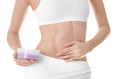 Photo of Young woman applying natural scrub on her belly against white background