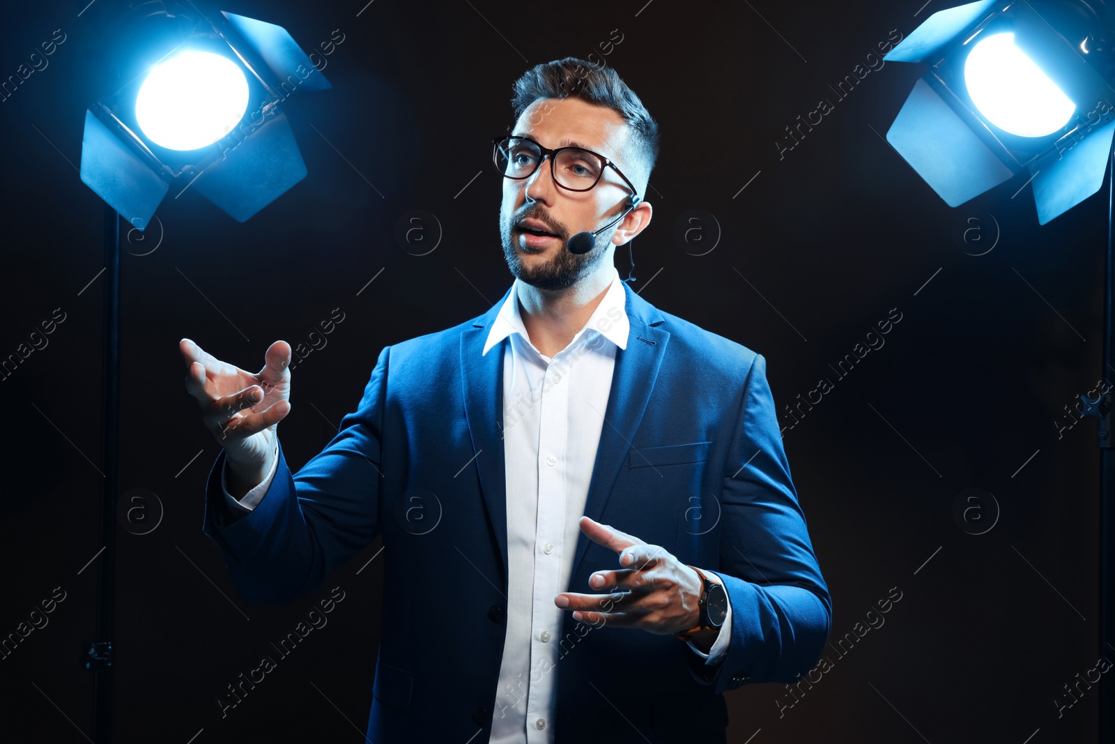 Photo of Motivational speaker with headset performing on stage