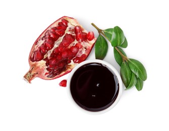 Photo of Tasty pomegranate sauce in bowl, branch and cut fruit isolated on white, top view