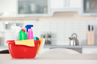 Basin with cleaning supplies on table indoors