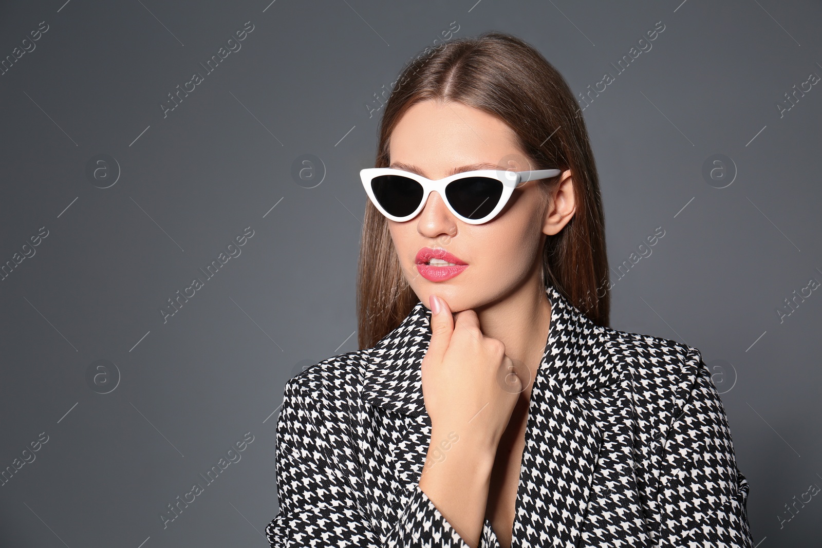 Photo of Young woman wearing stylish sunglasses on grey background. Space for text