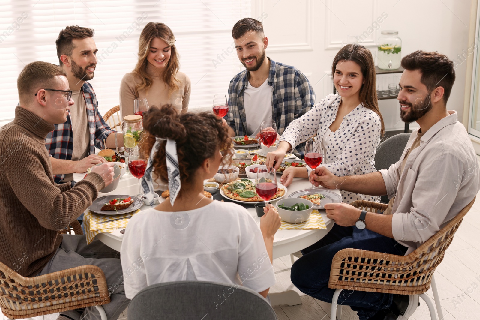 Photo of Group of people having brunch together at table indoors