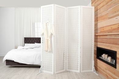 Photo of Modern folding screen in stylish bedroom interior