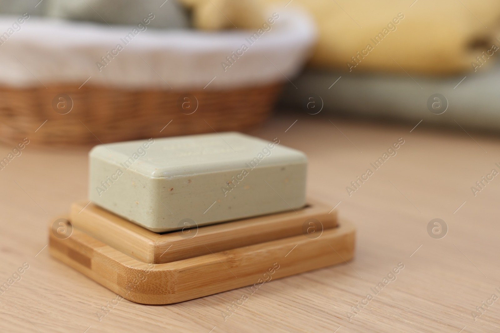 Photo of Soap bar on light wooden table, space for text. Spa therapy
