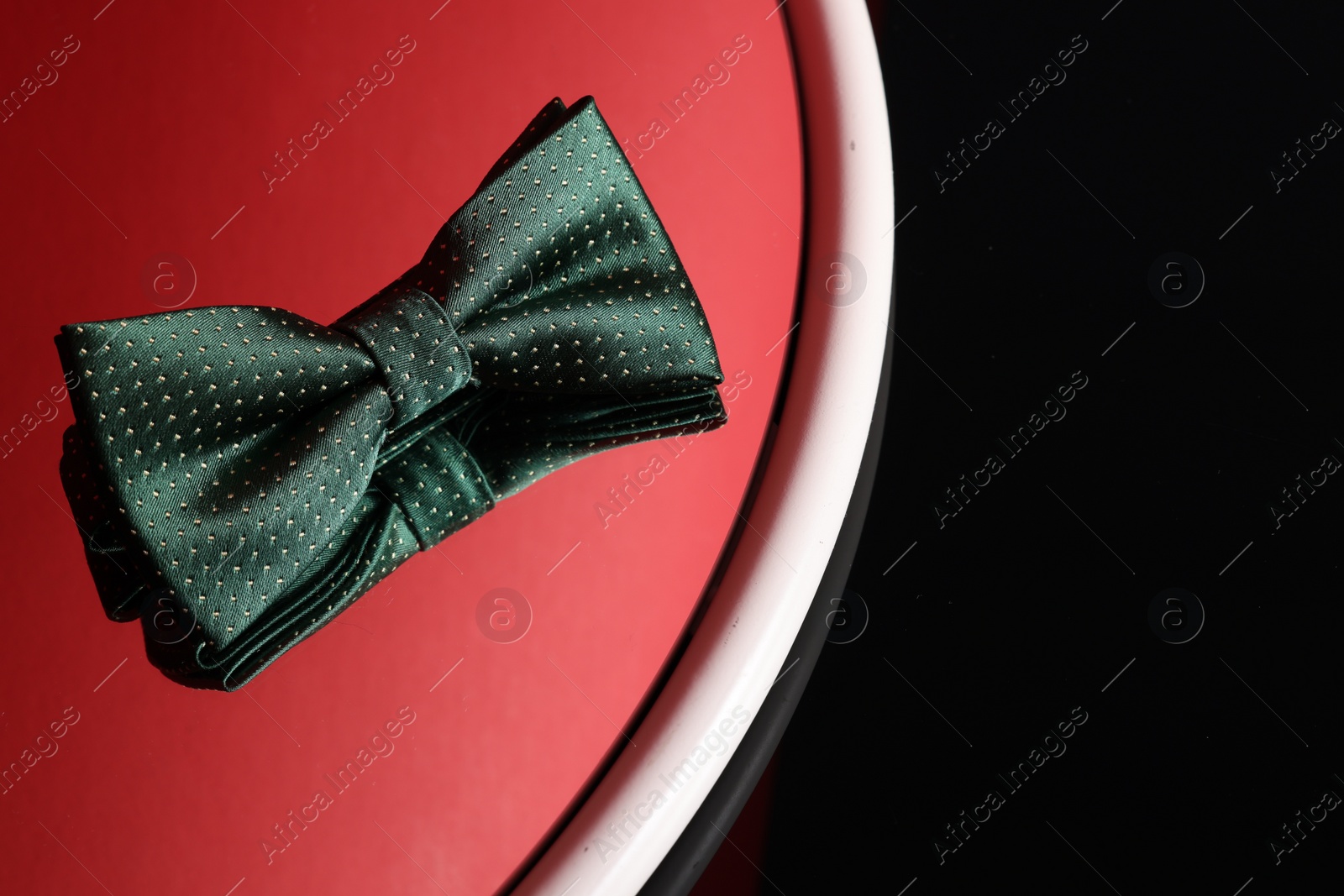 Photo of Stylish green bow tie on color background