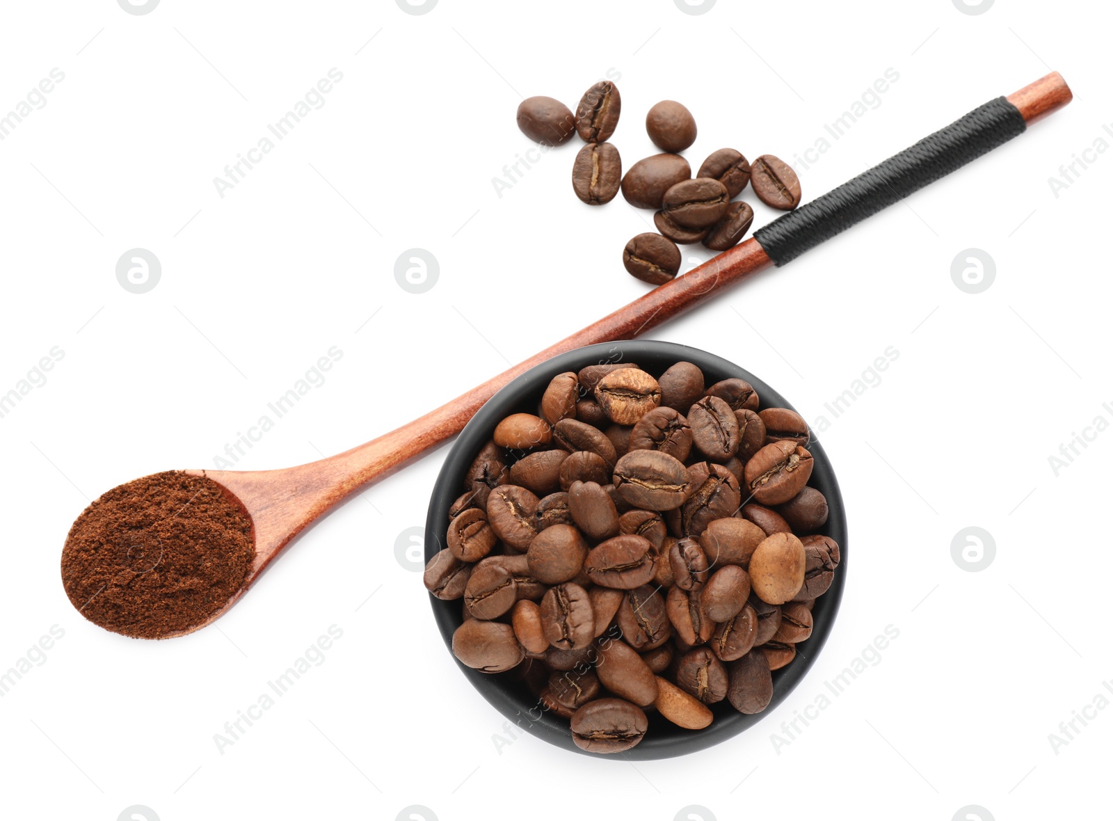 Photo of Spoon with coffee grounds and roasted beans on white background, top view