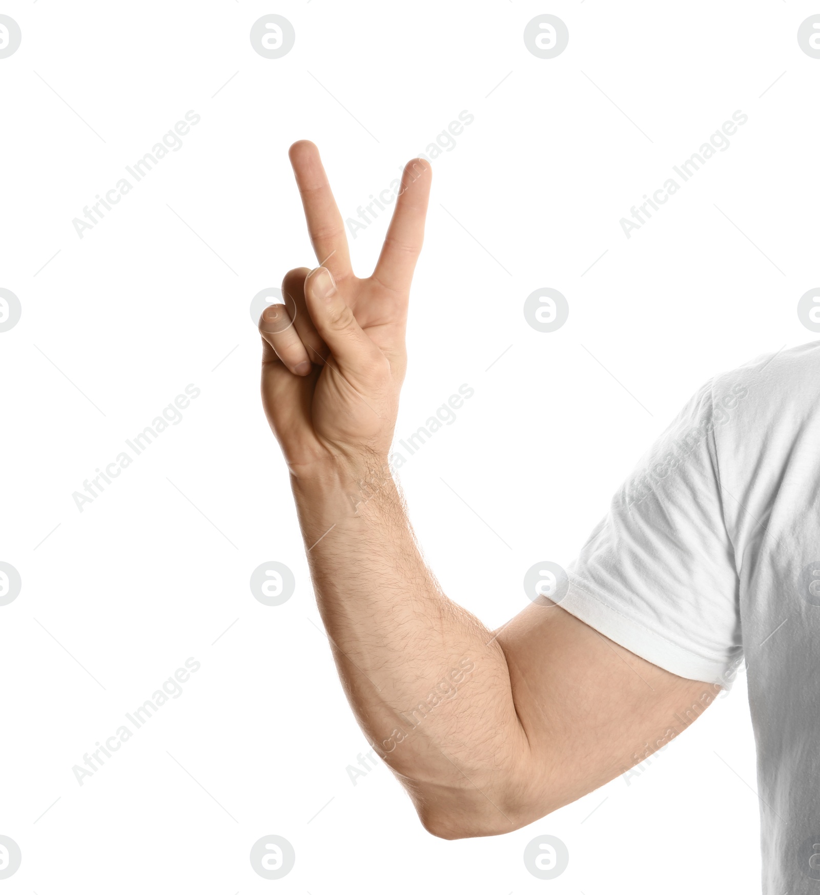 Photo of Young man showing victory gesture on white background