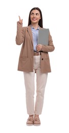 Beautiful happy businesswoman with laptop pointing at something on white background