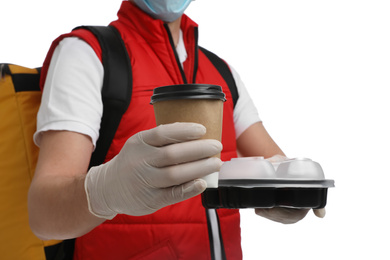 Photo of Courier in protective gloves with drink and food order on white background, closeup. Food delivery service during coronavirus quarantine