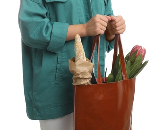 Woman holding leather shopper bag on white background, closeup