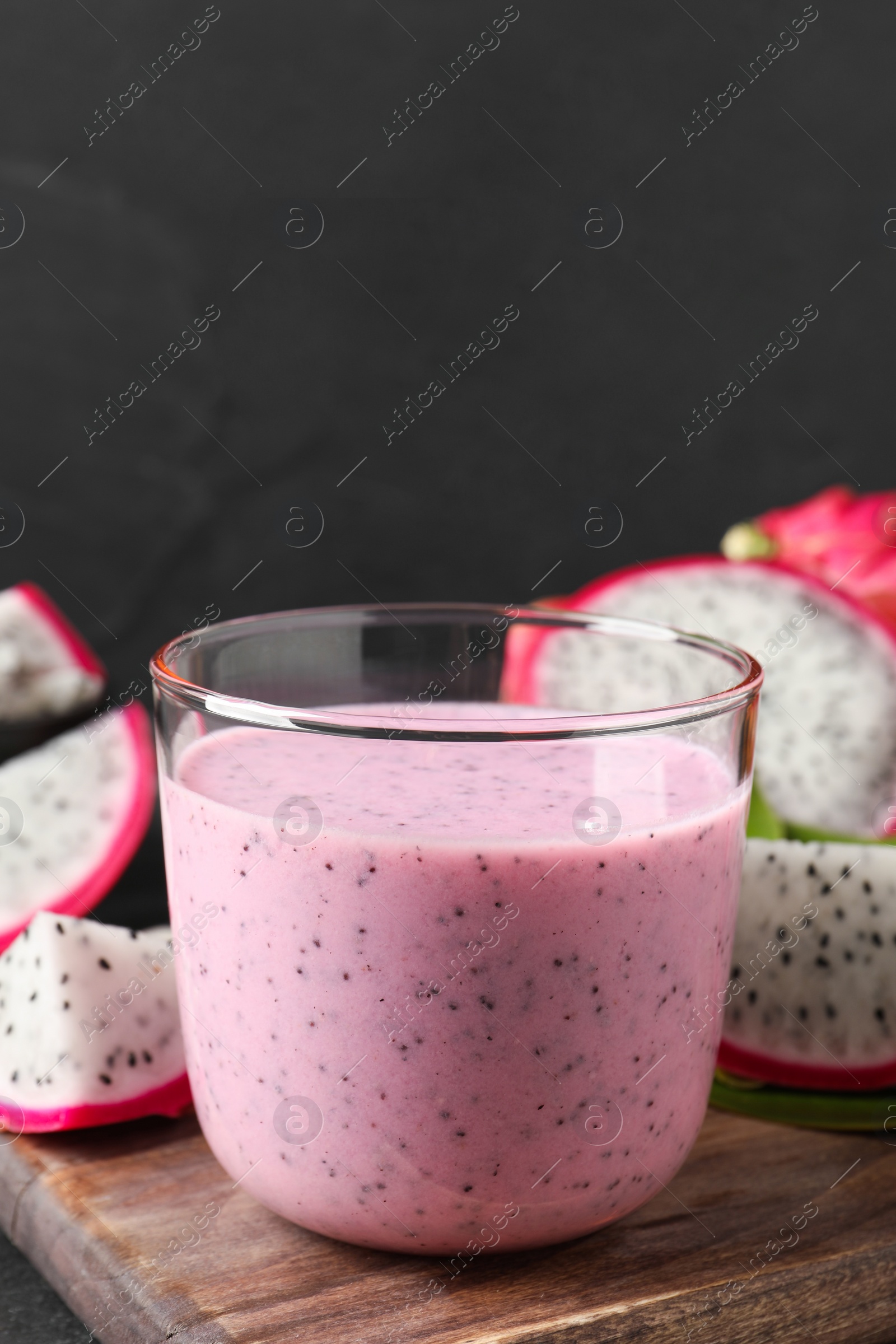 Photo of Delicious pitahaya smoothie and fresh fruits on table, closeup