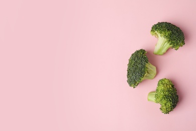 Photo of Flat lay composition with fresh green broccoli and space for text on color background