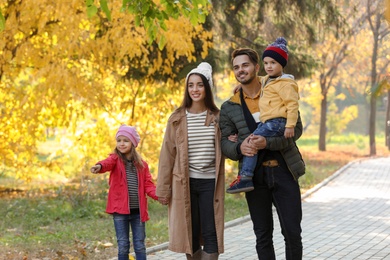 Happy family with children together in park. Autumn walk