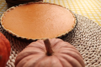 Photo of Delicious homemade pumpkin pie in baking dish on table