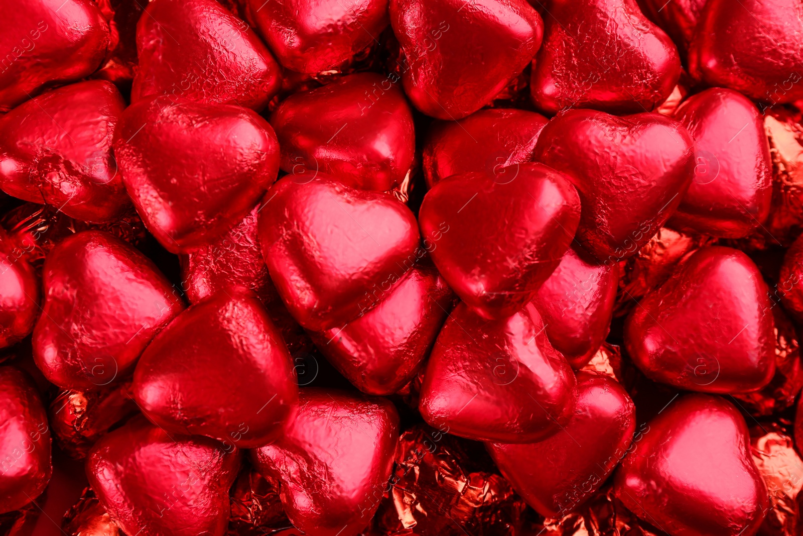 Photo of Heart shaped chocolate candies as background, top view