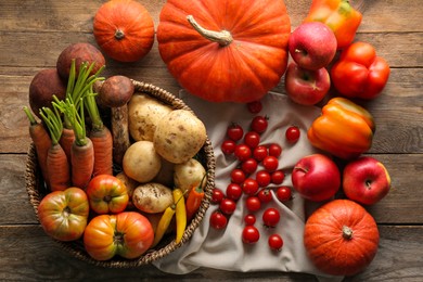 Photo of Different fresh ripe vegetables and fruits on wooden table, flat lay