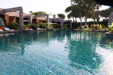 Blurred view of swimming pool and exotic plants at luxury resort